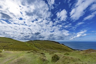 Vast rolling countryside with green meadows and sea views on the edge of Snowdonia National Park,