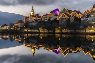 Christmas illuminated house facade of Frohnleiten reflected in the river Mur, Frohnleiten, Styria,