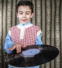 Child hold lp. Vontage clothes
