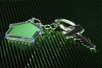 Keychain figure of house and key close up