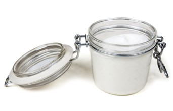 Jar of cream with a steel lock on a white background