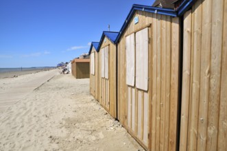 Wooden beach huts with blue roof