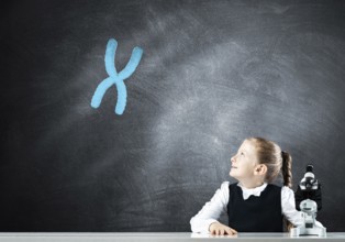 Little girl scientist with microscope on chalkboard background with x chromosome. Research and