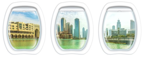 Three plane windows on Dubai skyscrapers skyline, United Arab Emirates, from a plane on the