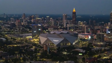 Aerial views of Atlanta showcase a vibrant cityscape with sleek skyscrapers, lush green spaces, and