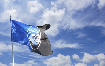 Atalanta flag waving against blue sky with white clouds. Space for text. Bergamo, ITALY - December