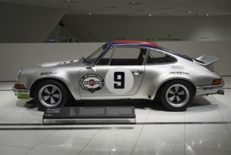 Porsche 911 Carerra RSA silver Porsche 911 on display in the museum with Martini Racing design, New