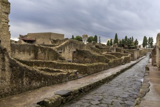 Ercolano, Italy, 25 November, 2023: typical city street and houses in the ancient Roman town of