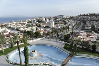 On the way to Ephesus, Lycia, view of urban landscape with swimming pool and palm trees, surrounded