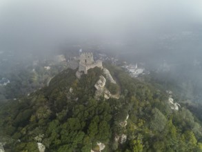 Aerial view of Castelo dos Mouros or Moorish Castle in fog, Sintra, Portugal