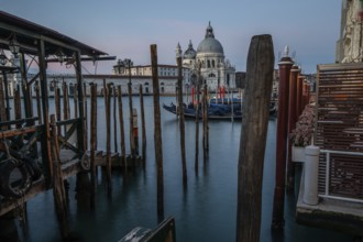 Gondola jetty, Venetian gondolas with the church of Santa Maria della Salute in the background,