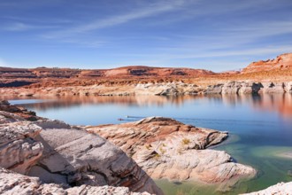 Lake Powell. The water reflects the surrounding shores. The smooth emerald water of the lake