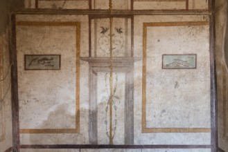 POMPEII, ITALY, MAY 04, 2022, Scenic ancient frescoes in a room of a Pompeiian villa, Southern