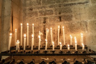 An image of some burning candles in a church in Italy