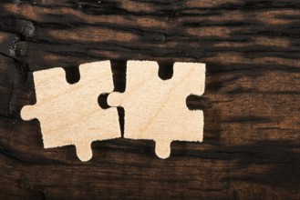 Wooden puzzle on dark wooden background