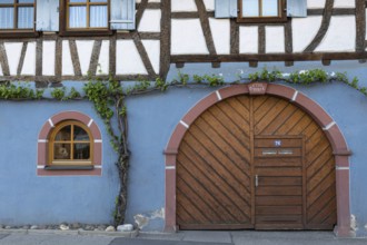 Traditional half-timbered house with wooden door and blue-painted façade, Eichstetten am