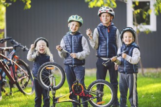 Children mechanics, bicycle repair. Happy kids fixing bike together outdoors in sunny day. Bicycle