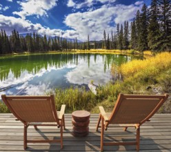 Two wooden deckchairs for tourists on ashore shallow round lake. Autumn day in Jasper National Park