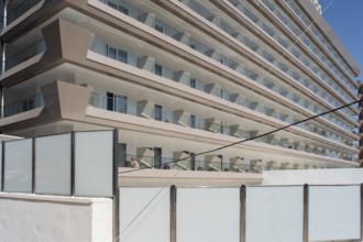 Woman sunbathing on the balcony of Hotel Helios in Benidorm, Alicante province, Spain