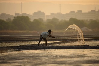 Men working in salt pans, Wadala, Mumbai, Maharashtra, India, Asia
