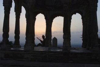 Folksinger playing ravanhatta at sunrise in cenotaph, Rajasthan, India
