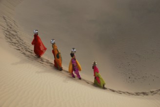 Girls climbing dune, Khuhri, Jaisalmer, Rajasthan, India