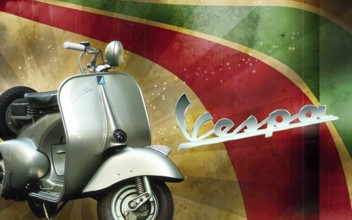 Classic Vespa scooter parked against a backdrop of Italian flag colors