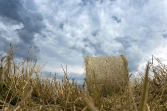 Straw bales on farmland Storm clouds
