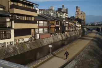 26.12.2017, Kyoto, Japan, Asia, A man walks along the banks of the Kamo River in Kyoto early in the