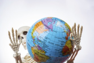 The earth in a skeleton hand