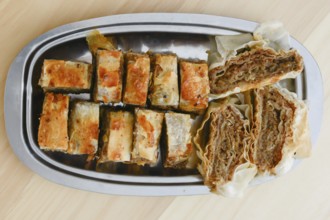 Traditional serbian cake baklava arranged on metal plate for serving on Saint day