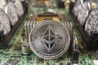 Ethereum coin close-up on a computer circuit motherboard as a blockchain technology payment network