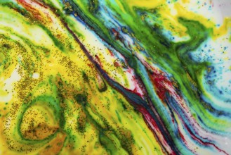 Multicoloured background of bright colours covered with gold sparkles
