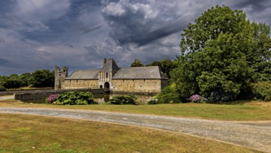 Castle with water and gardens in a tranquil landscape under a dramatic sky, Gratot Castle in