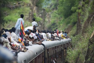 People sitting on train roof, Rajasthan, India