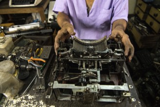 Technician repairing an old manual typewriter Mumbai, Maharashtra, India, Asia