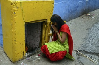 Woman praying at temple, Jodhpur, Rajasthan, India, Asia