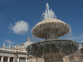 An impressive fountain in the centre of an ancient architectural setting under a clear blue sky,