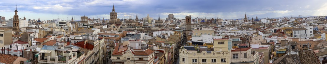 Panoramic photo of the rooftops of Valencia with the towers of the city's churches, as well as the