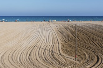 Alicante, Spain, October 13, 2023: Furrows in the sand from sand cleaning raking in the beach of