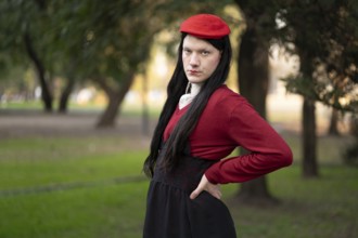 Transgender woman posing sensually in a park