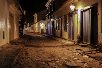 Atmospheric night view of illuminated street and buildings in historical center of Paraty, Brazil,