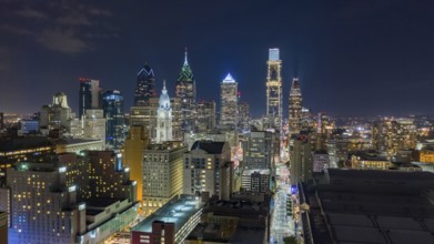 Aerial view night sky over the neighborhoods and streets of Philadelphia PA USA