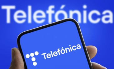 Telefonica logo is displayed on smartphone