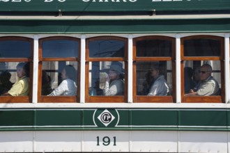 14.06.2018, Porto, Portugal, Europe, Tourists look out of the window during a tram tour through