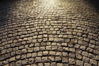 Gloomy old cobblestone pavement. Beautiful natural background