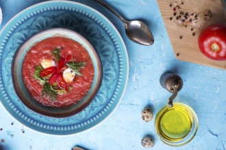 Classic spanish raw eating cold soup Gazpacho served at blue table. flat lay. food recipe. healthy
