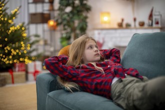 A young child lounges comfortably on a plush sofa, thoroughly enjoying the warm and cozy atmosphere