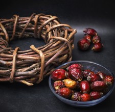 Rose in white bowl on background licorice root bound in coil