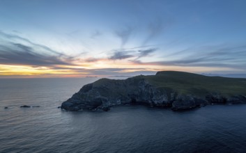 Sunset over the Atlantic Ocean and the cliffs of Bray Head on Valentia Island in County Kerry of